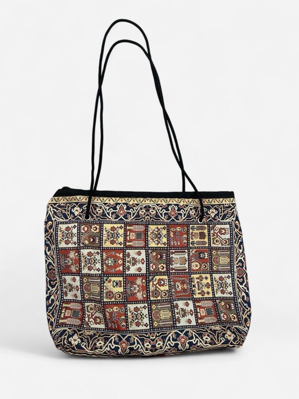 Multi-colored patchwork purse with repeating geometric and floral motifs